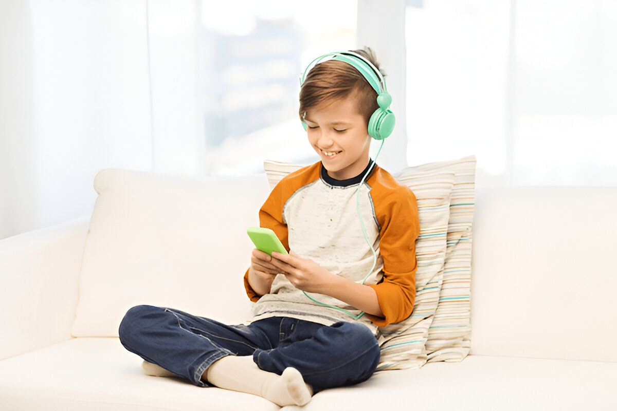 a boy playing on his phone to explore play-based learning options